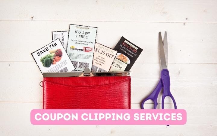 coupons tucked into red wallet next to a purple scissor on a beige table