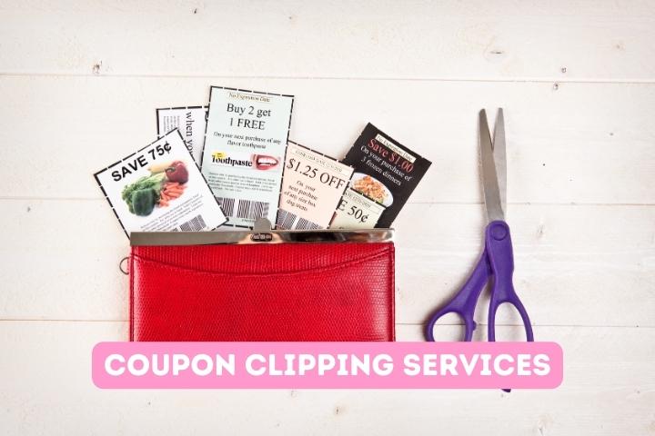 coupons tucked into red wallet next to a purple scissor on a beige table