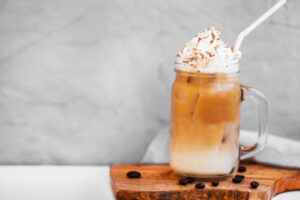 iced espresso drink in mason jar on wooden board