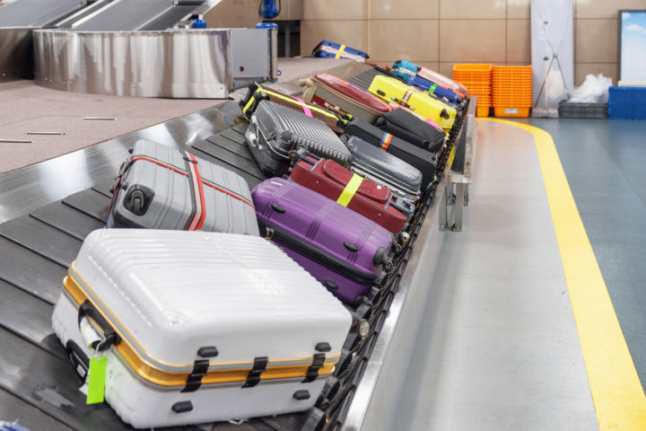 colorful luggage at baggage claim at airport