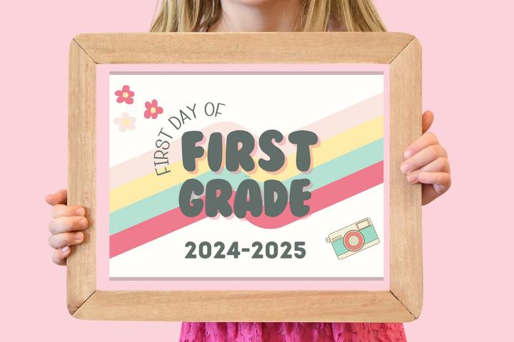 First Day of First Grade 2024-2025 with a retro 4 color rainbow in a wooden frame held my a girl