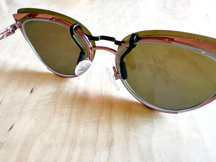 sunglasses clipped onto cat eye frames