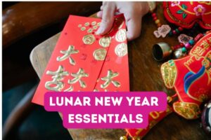 Text: Lunar New Year Essentials, Image: Red envelopes and Chinese New Year decorations on wood table