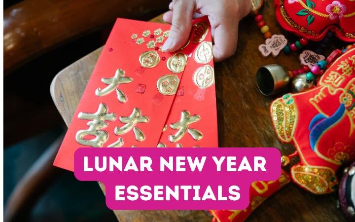 Text: Lunar New Year Essentials, Image: Red envelopes and Chinese New Year decorations on wood table